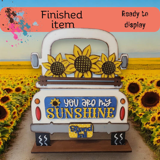 a truck parked in a field of sunflowers