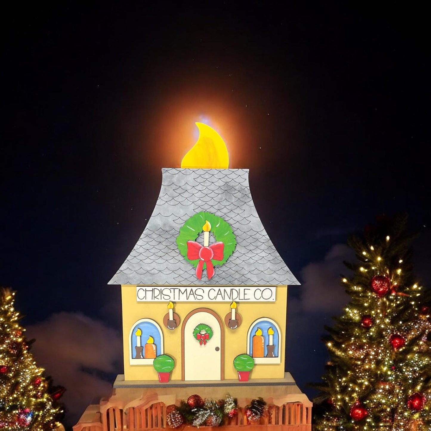 a lit up christmas tree and a lit up building