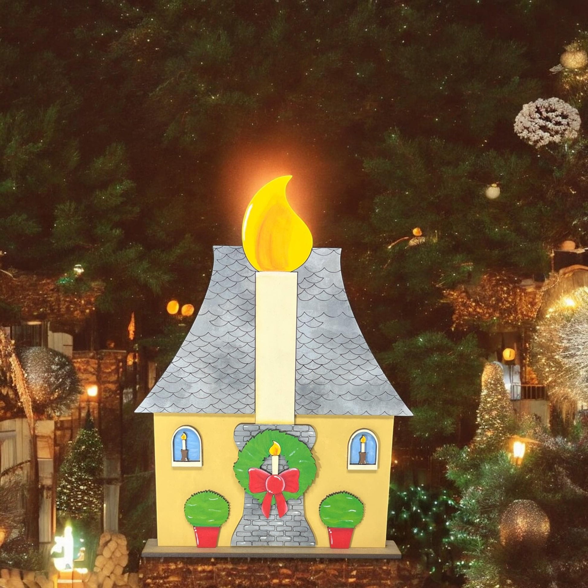 a lighted house with a lit candle on top of it