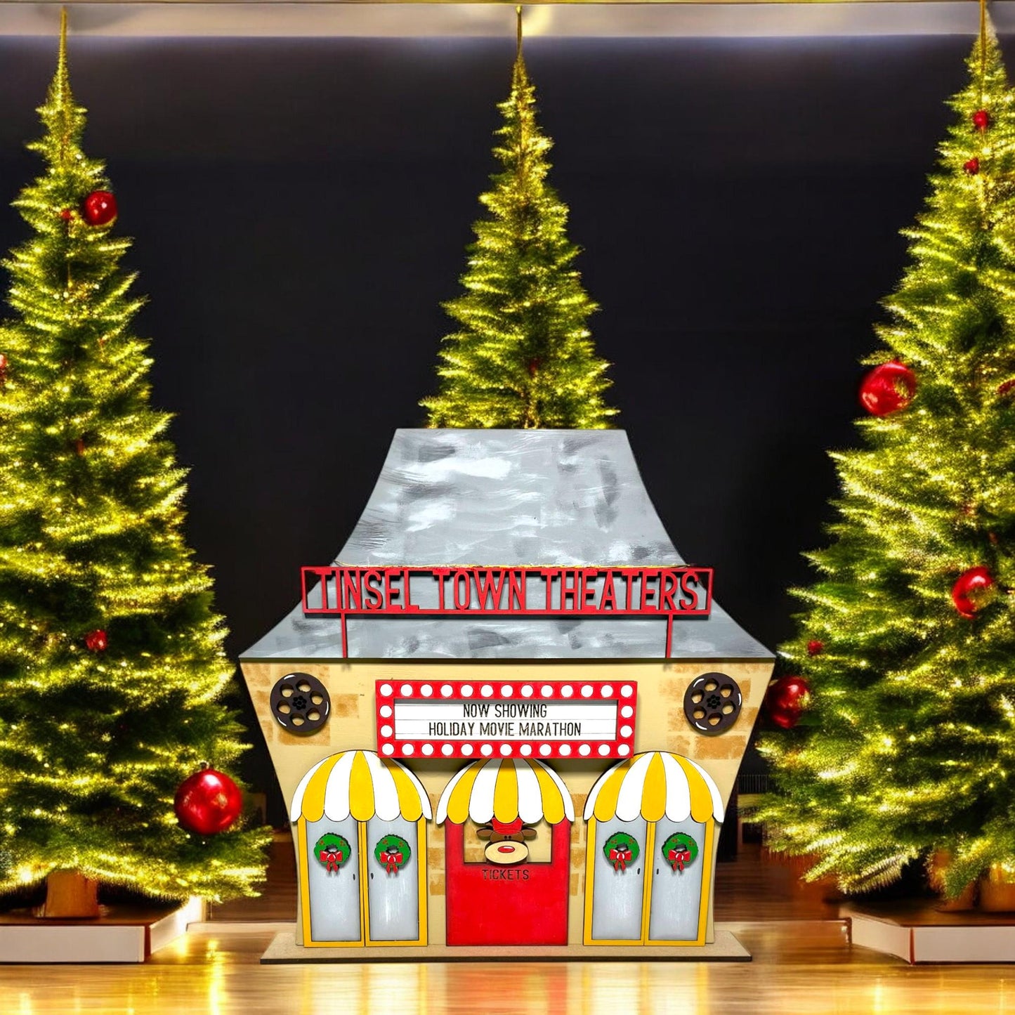 a christmas display with a train and trees in the background