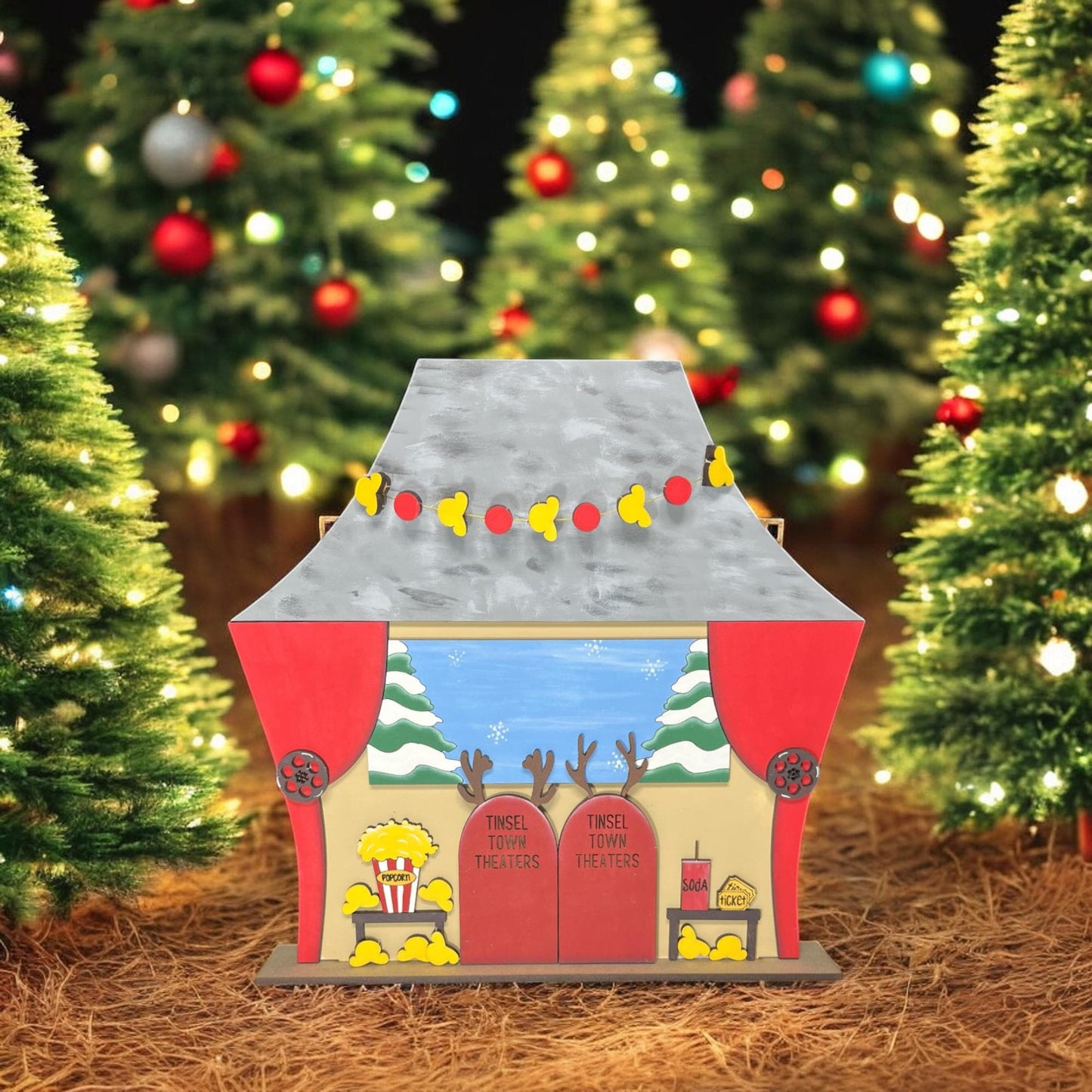 a toy house with a christmas tree in the background