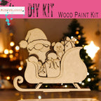 a wooden cutout of a santa sleigh with a teddy bear
