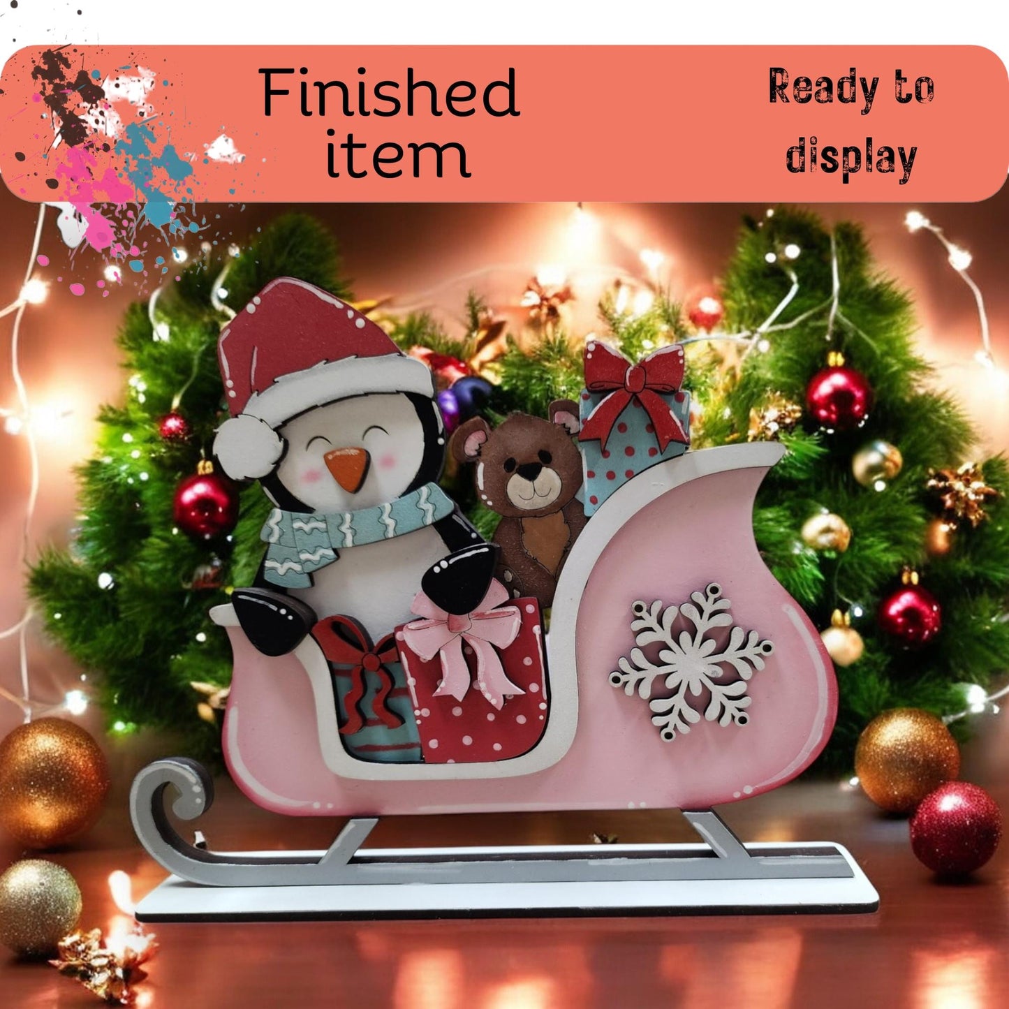 a pink sleigh with a penguin and a bear on it