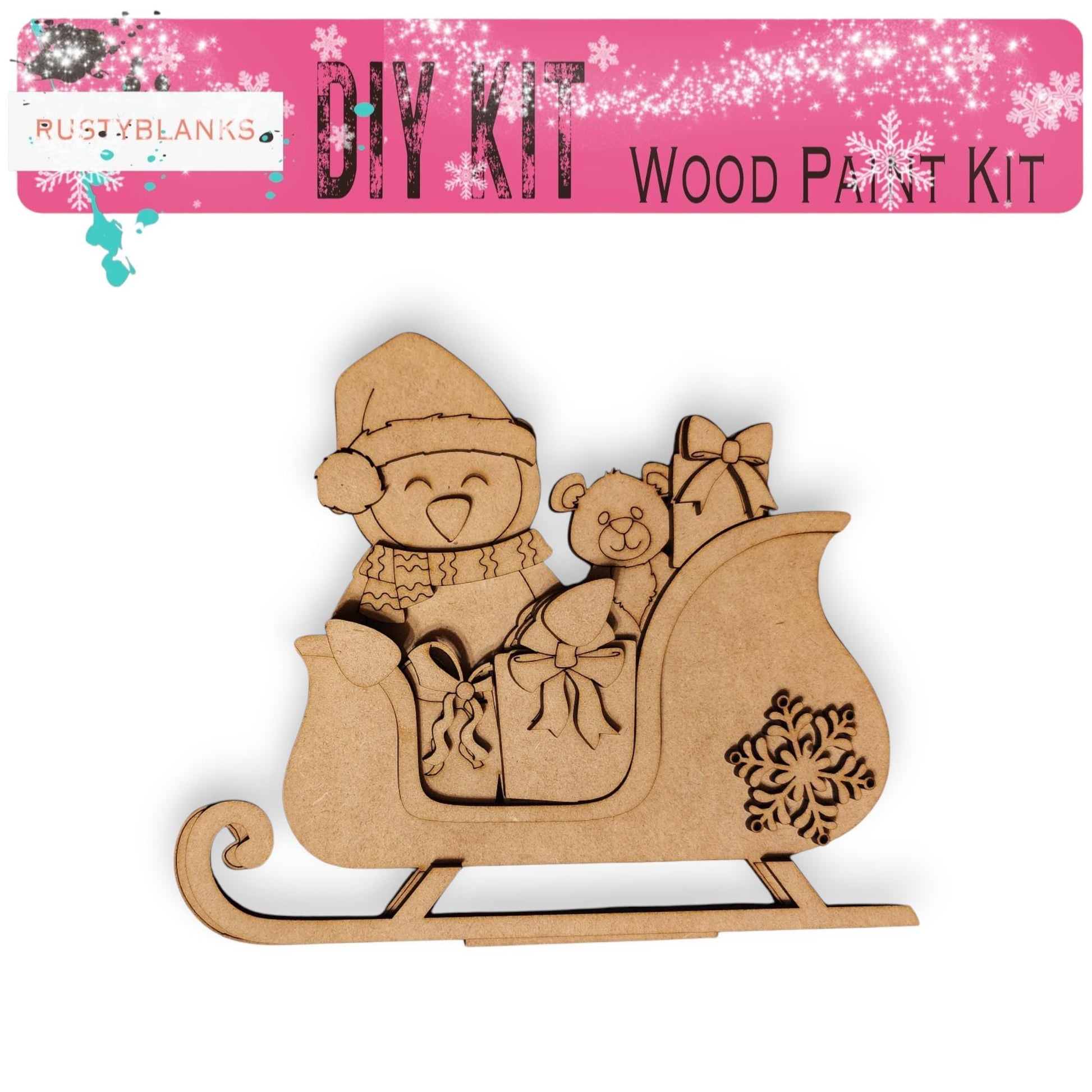 a wooden cutout of a baby in a sleigh with a teddy bear