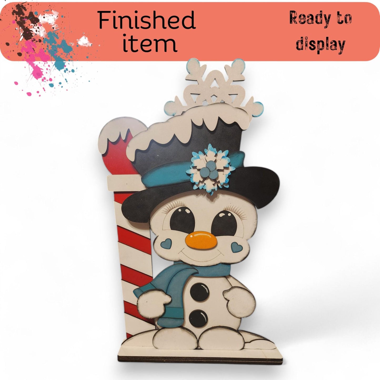 a wooden snowman with a hat and scarf