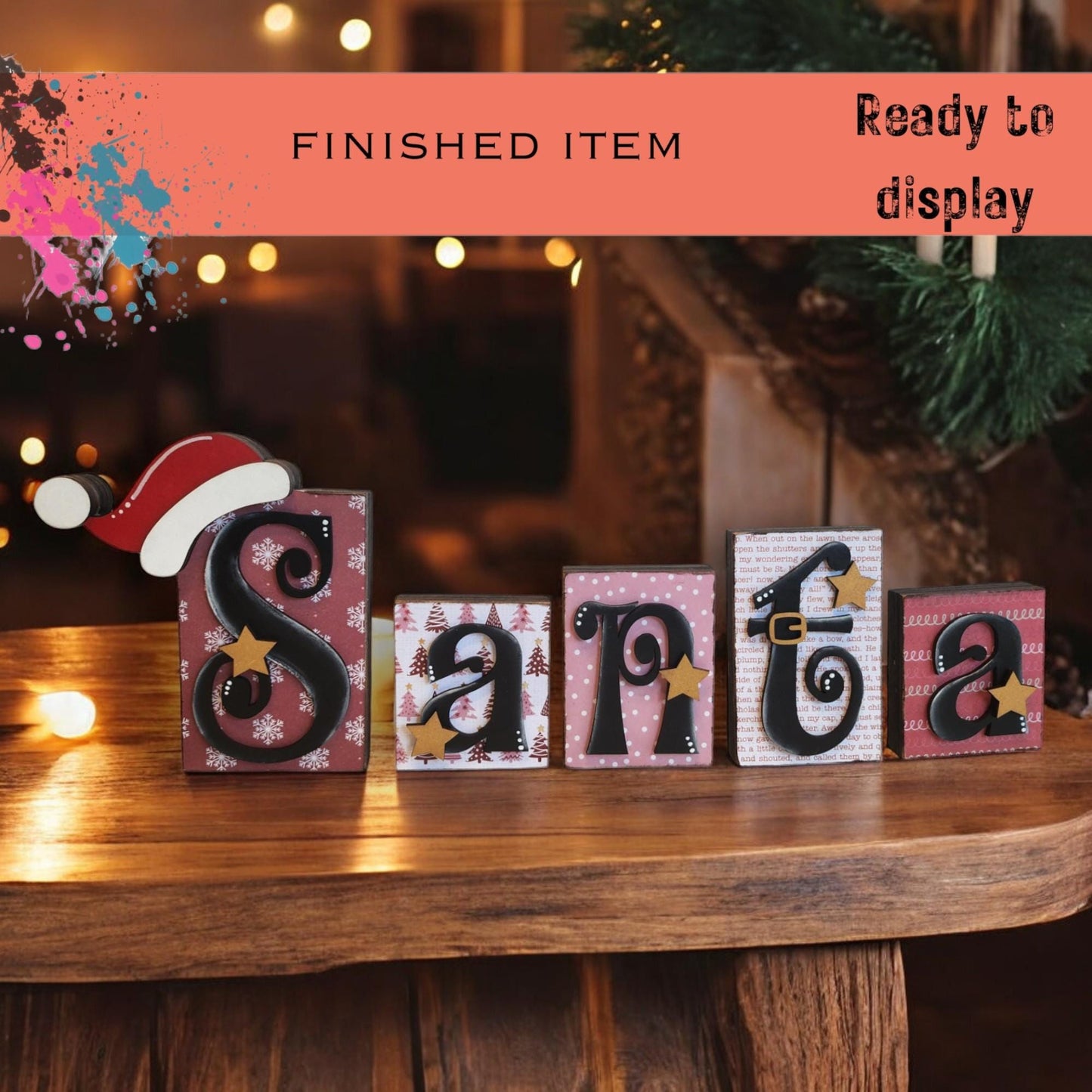 a wooden table topped with blocks that spell santa