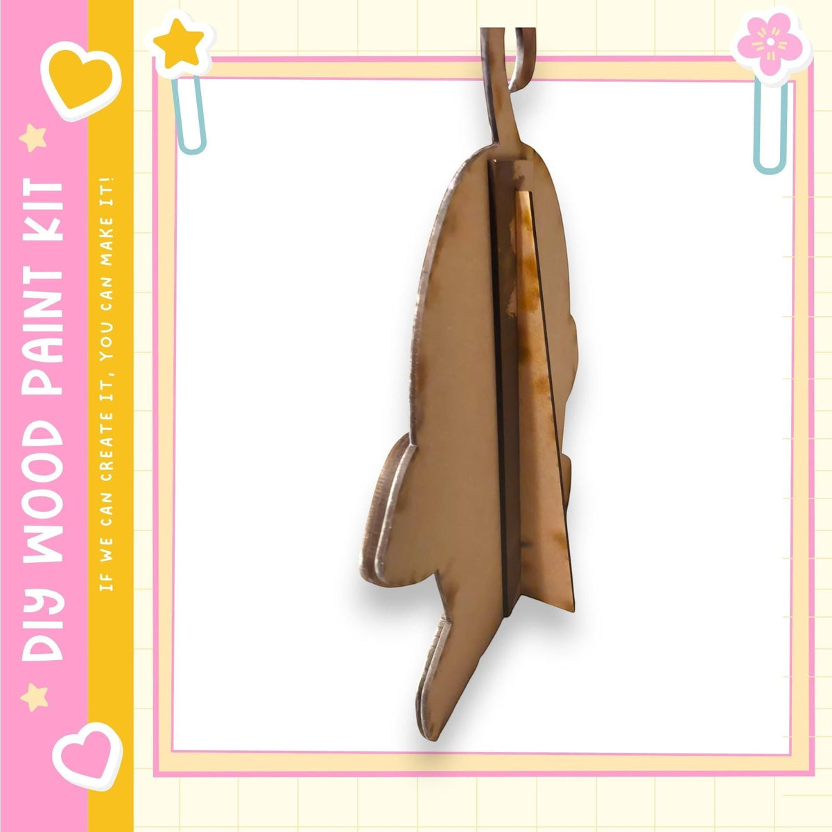 a wooden rocket ship hanging from a string.